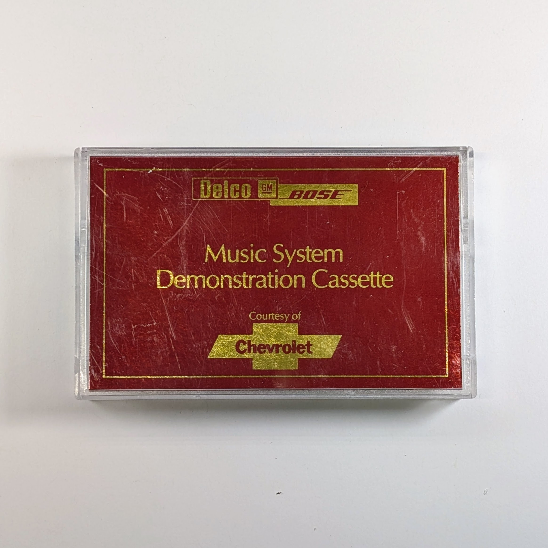 Music System Demonstration Cassette Delco/GM/Bose/Chevrolet - Red